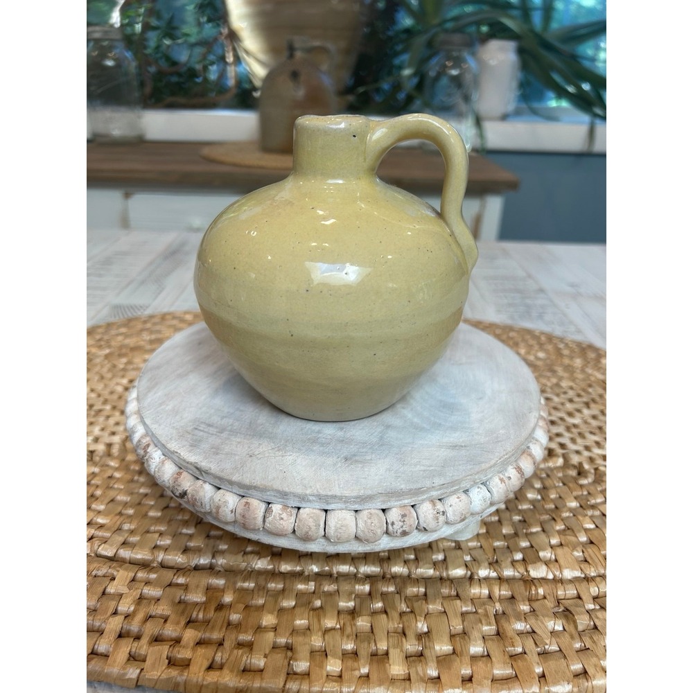 I rage‎ yellow stoneware jug.